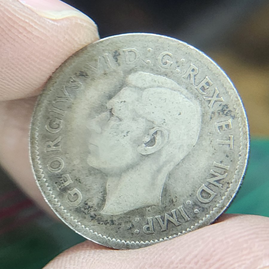 1940s George VI silver coin held in hand